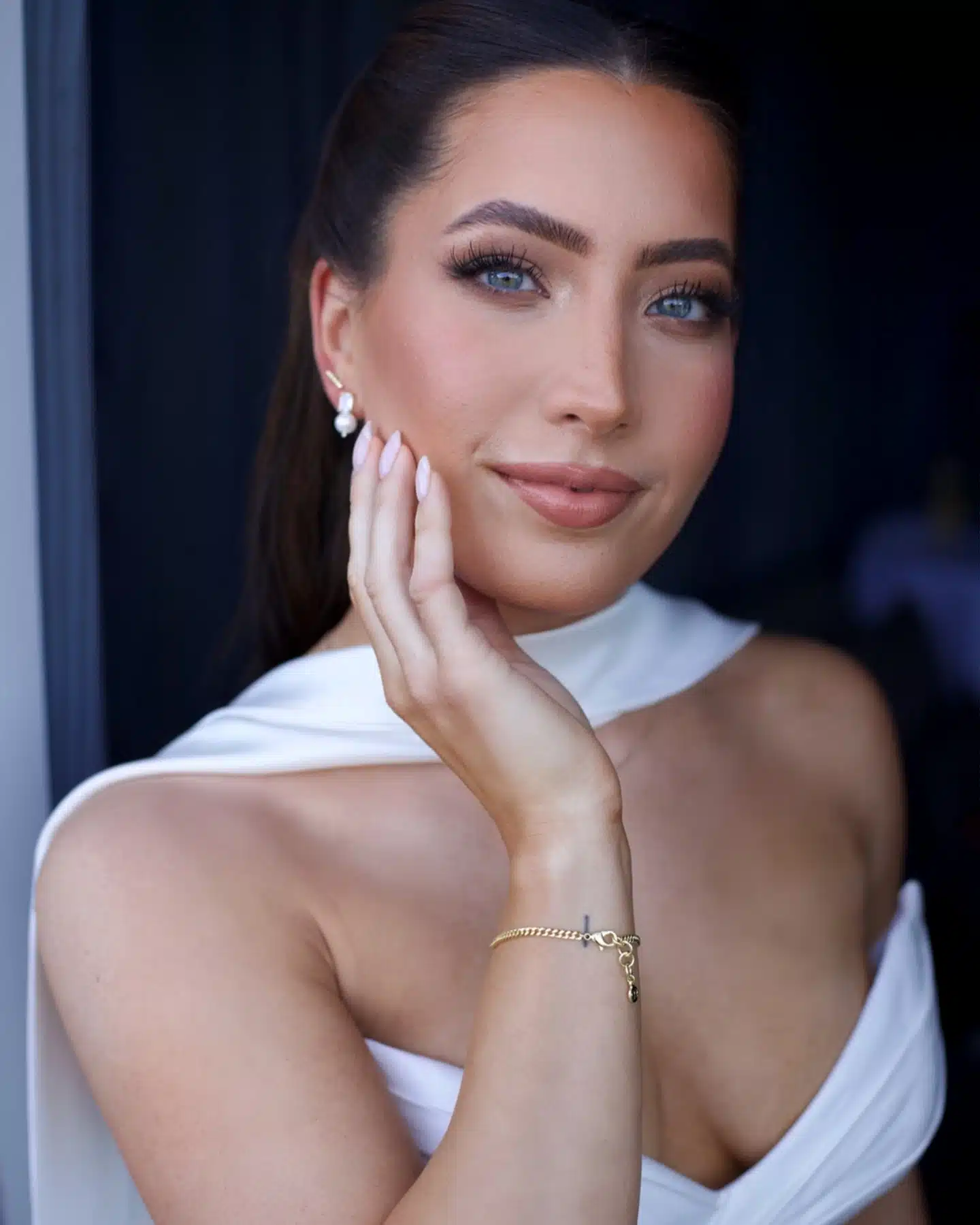 Bride with a sleek half-up style and luminous bridal makeup
